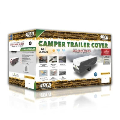 A boxed product package for an ADCO Camper Trailer cover, shown on a clean white background. The box is mostly white with green and yellow branding, a photo of a camper trailer covered by the product, and several small feature icons along the bottom.